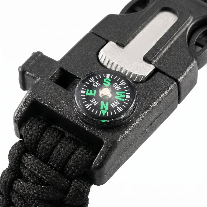 Black multi-tool with compass on a white background