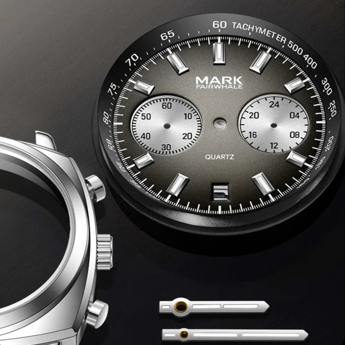 Disassembled AURIXON dial and watch hands showing tachymeter chronograph craftsmanship.