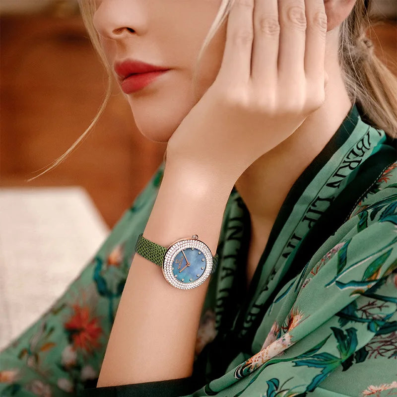 Elegant close-up – Woman wearing Mark Fairwhale DIAMÉRA diamond watch with green strap