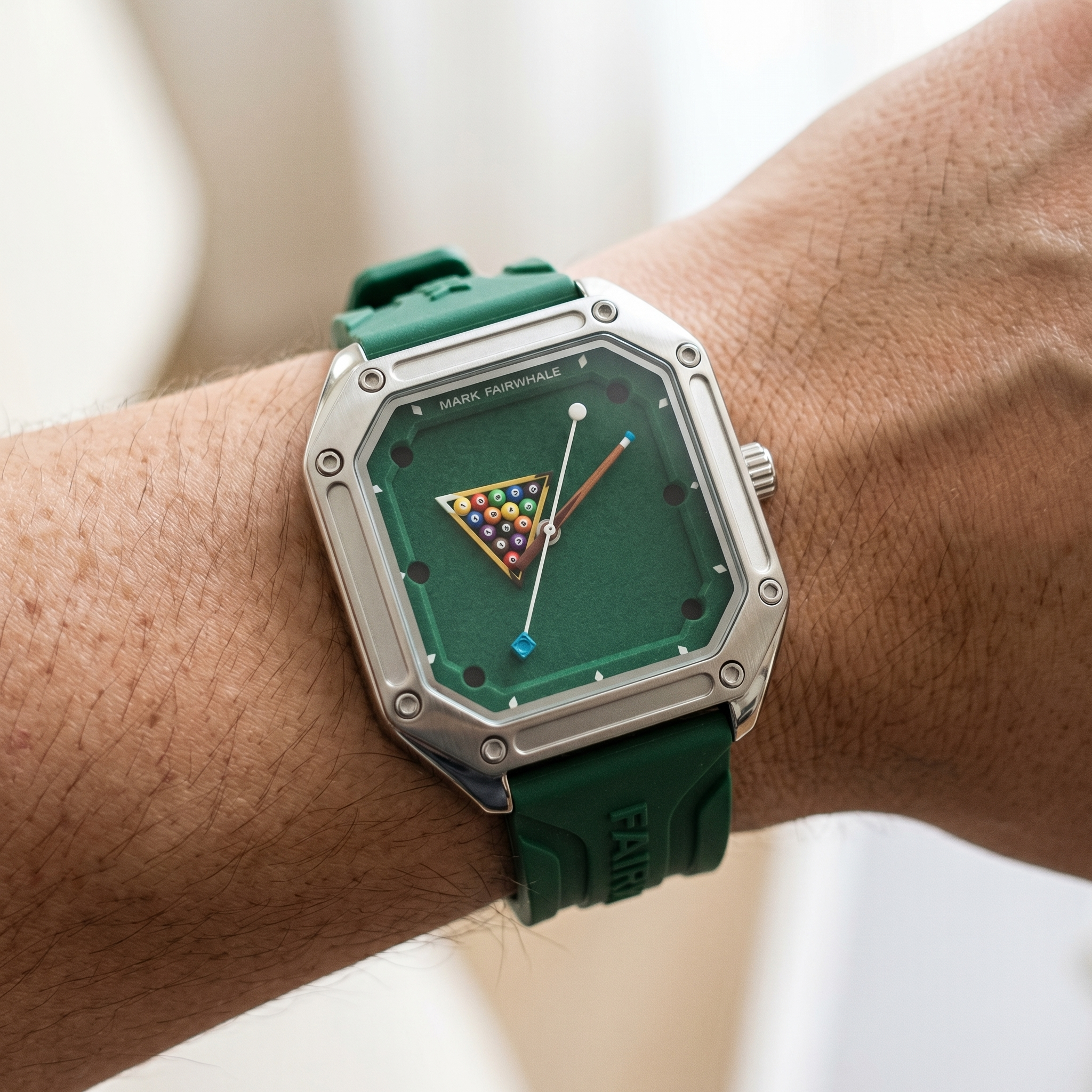 Green watch with a unique face on a wrist against a neutral background
