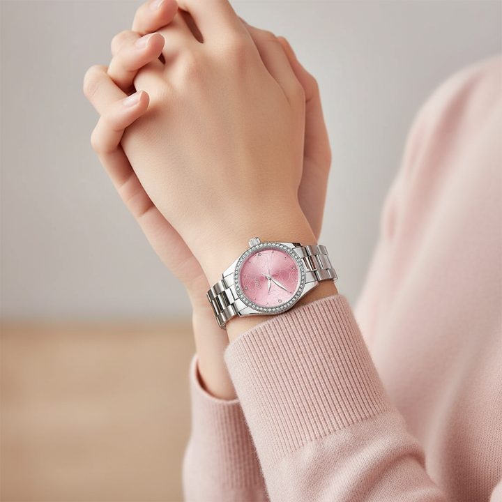 Hand wearing a pink watch with a light background