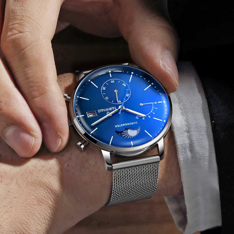 Man wearing MARK FAIRWHALE ASTRON quartz moon phase chronograph blue dial mesh watch”