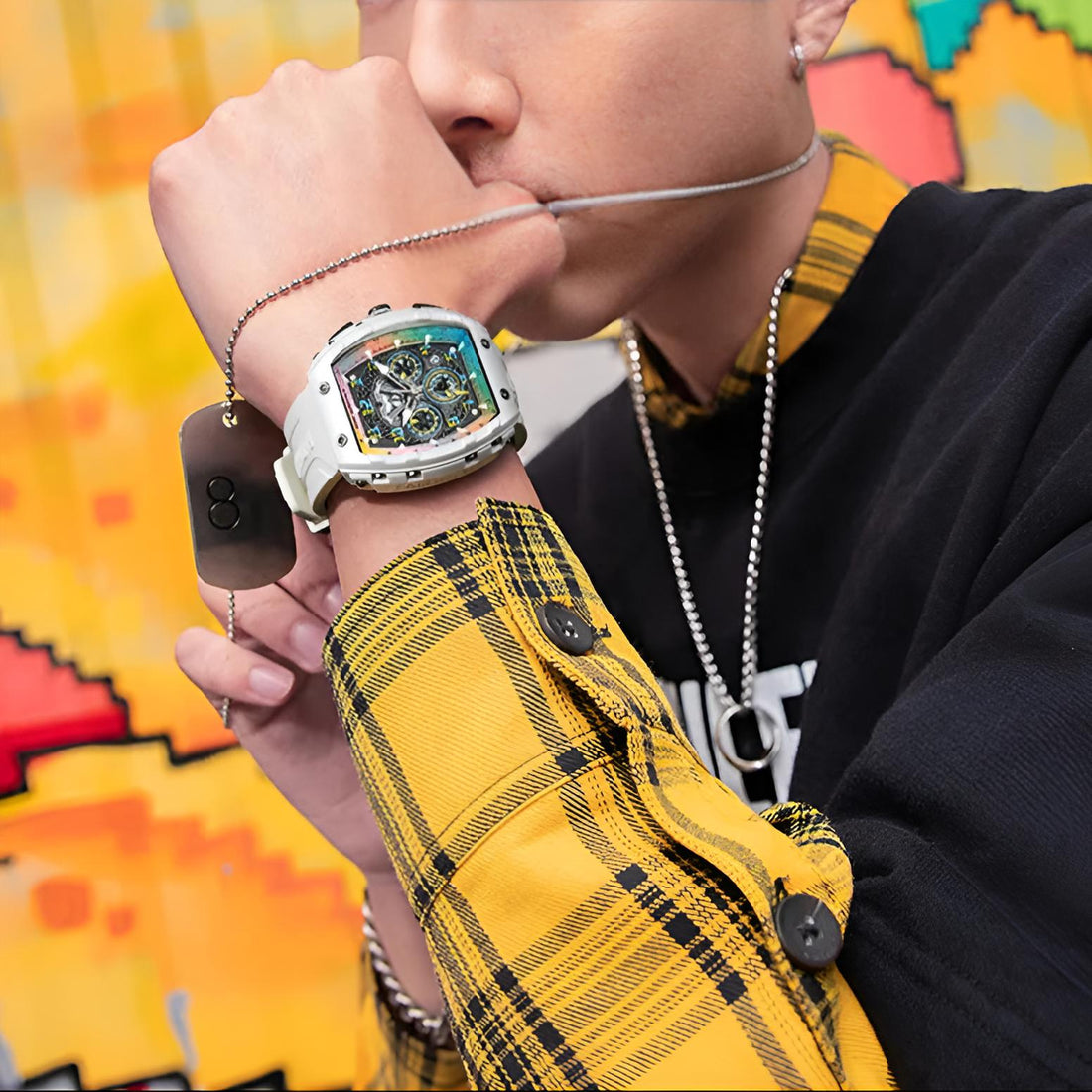 Lifestyle shot of man wearing Mark Fairwhale TONIXA fashion watch with white strap and bold rainbow dial