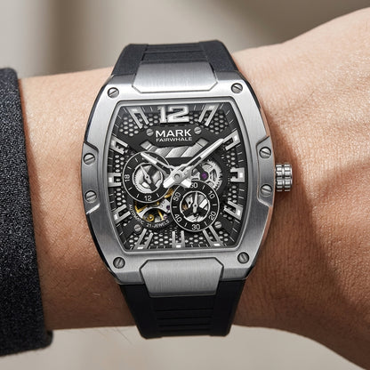 Luxury watch with black strap and detailed face on wrist against a neutral background