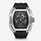 Luxury watch with black strap and transparent face on a white background