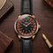 Luxury watch with brown leather strap and intricate face on a wooden surface