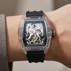Luxury watch with intricate design on a person's wrist against a neutral background