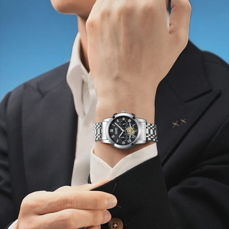 Man in suit wearing Mark Fairwhale 5036 NEXORA black dial luxury stainless steel quartz watch