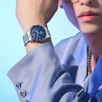 Man wearing Mark Fairwhale 5022 VELTRONIX watch with blue celestial dial, styled with a modern suit.