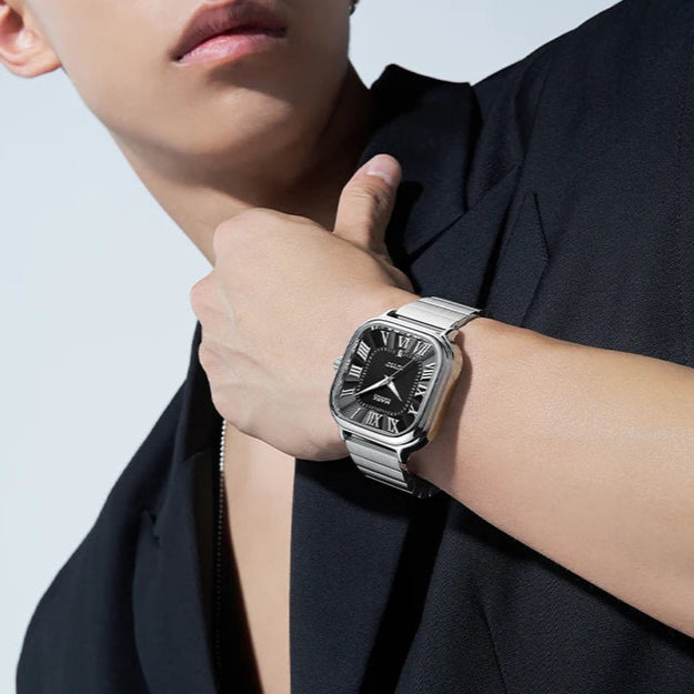 Man wearing Mark Fairwhale FW-6820 IONIRUS square automatic stainless steel watch with black dial.