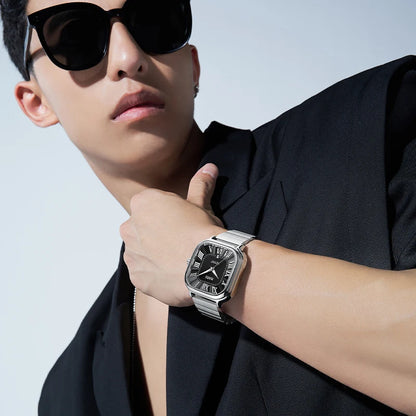 Man wearing Mark Fairwhale IONIRUS square automatic stainless steel watch with black dial.