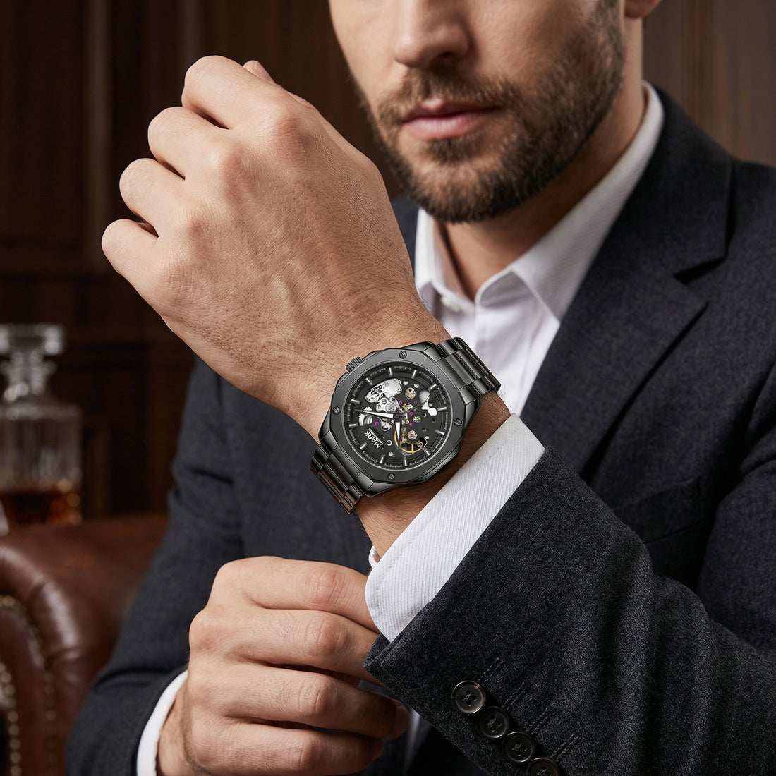 Man wearing a black wristwatch in a formal setting