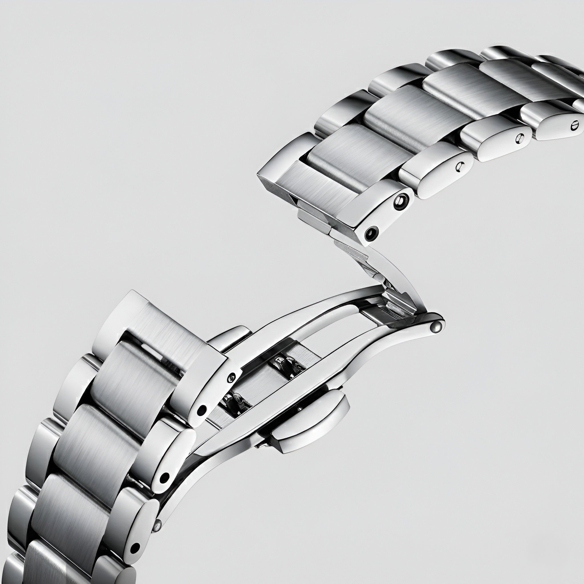 Mark Fairwhale FW 6027 skeleton automatic watch - Close-up of a silver watch band on a light gray background