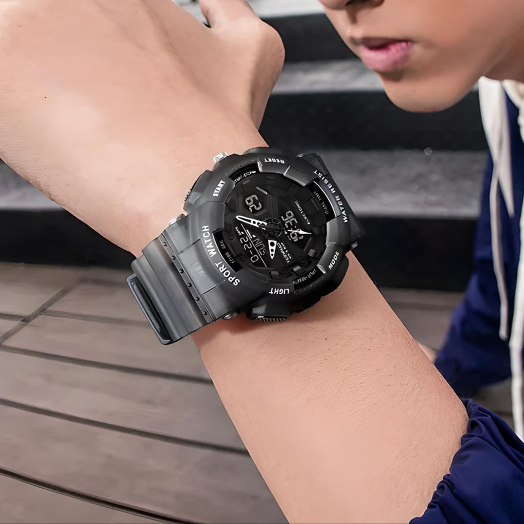 Mark Fairwhale 4370 VYBRO analog-digital watch with bright blue LED illumination showing dual time, calendar, and chronograph display in the dark.