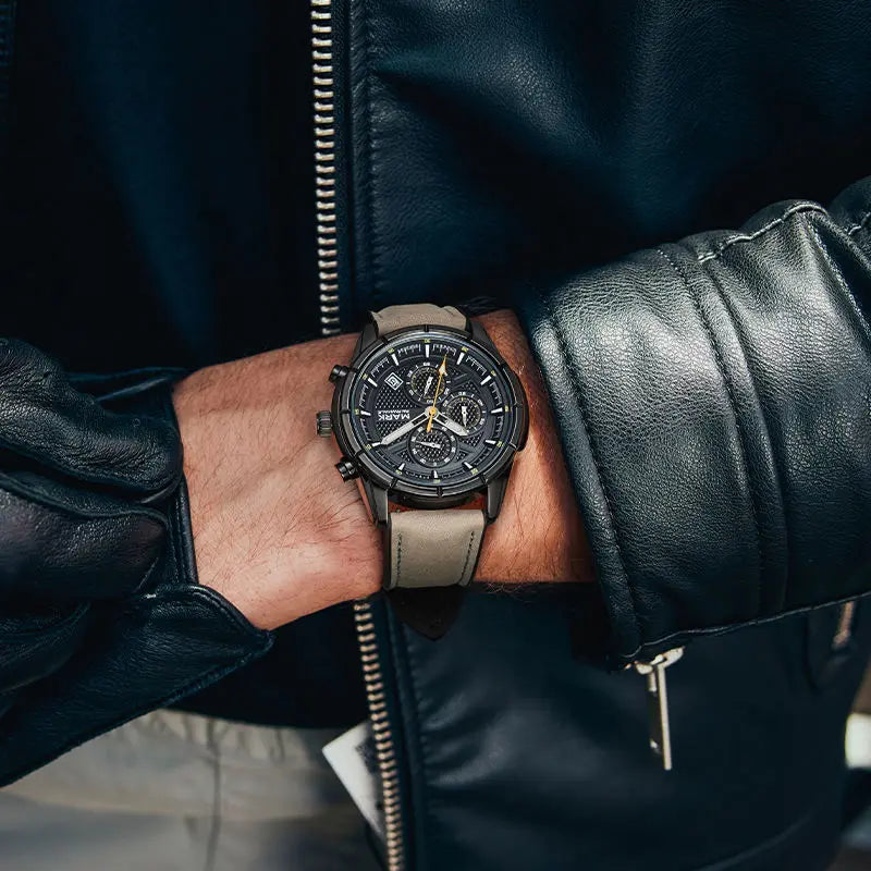 Mark Fairwhale NOVANTOR black dial watch with grey leather strap on wrist close-up