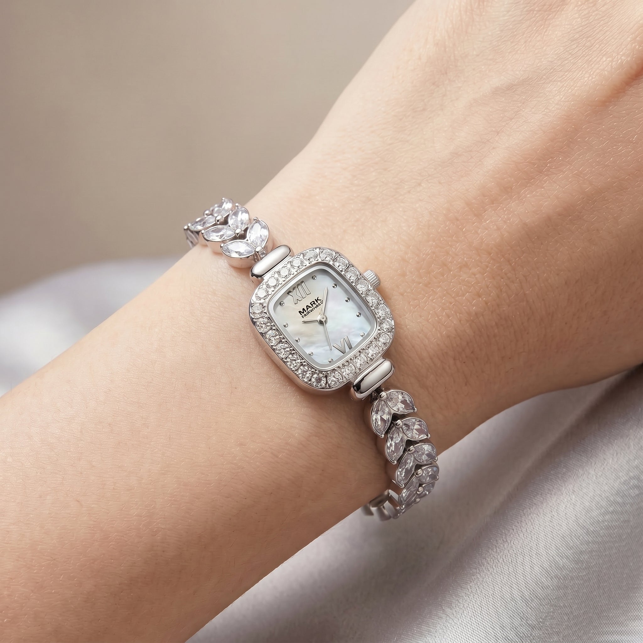 Mark_Fairwhale_silver_crystal_bezel_watch_with_mother_of_pearl_dial_on_feminine_wrist