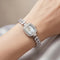 Mark_Fairwhale_silver_crystal_bezel_watch_with_mother_of_pearl_dial_on_feminine_wrist