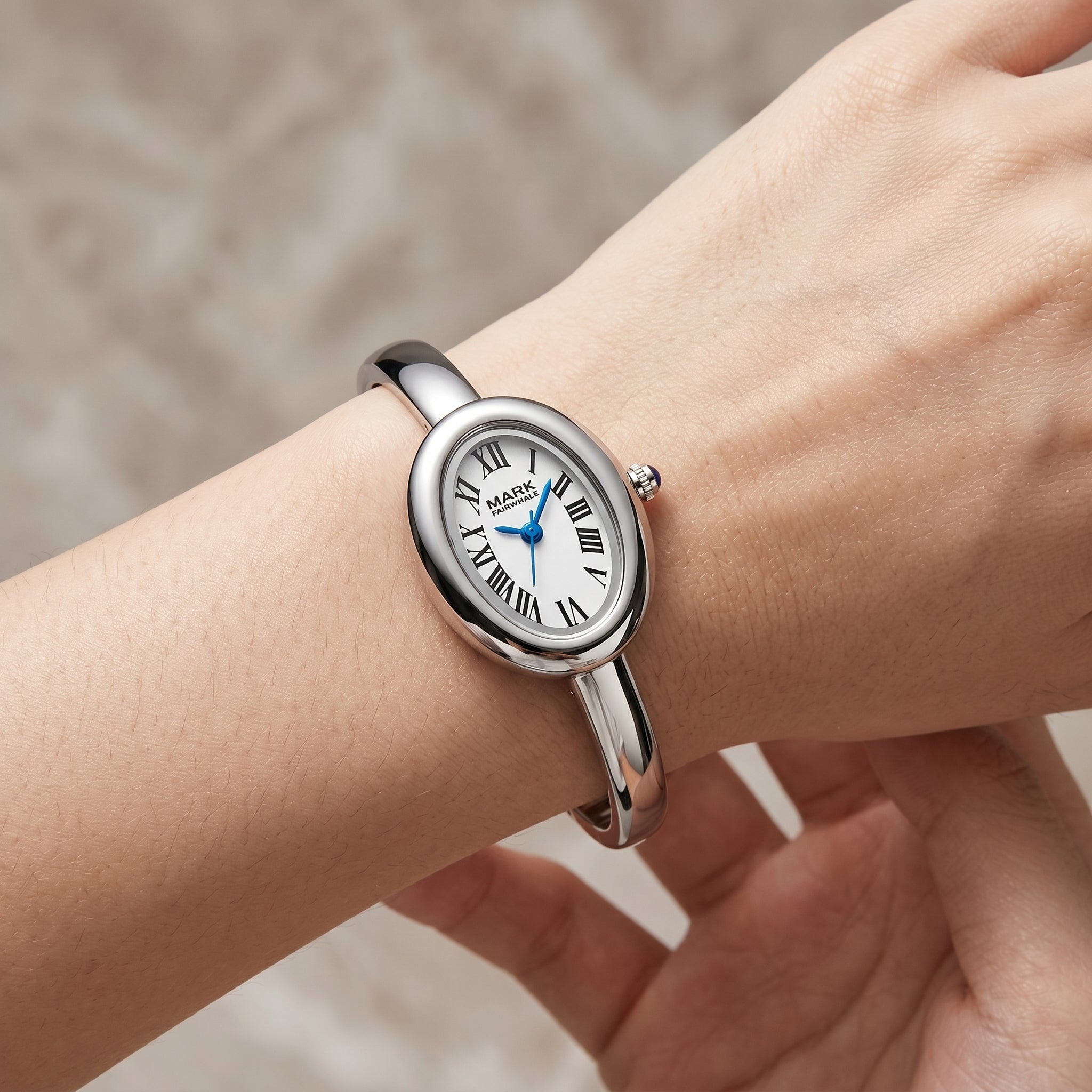 Mark Fairwhale silver women's watch with Roman numeral dial on feminine wrist