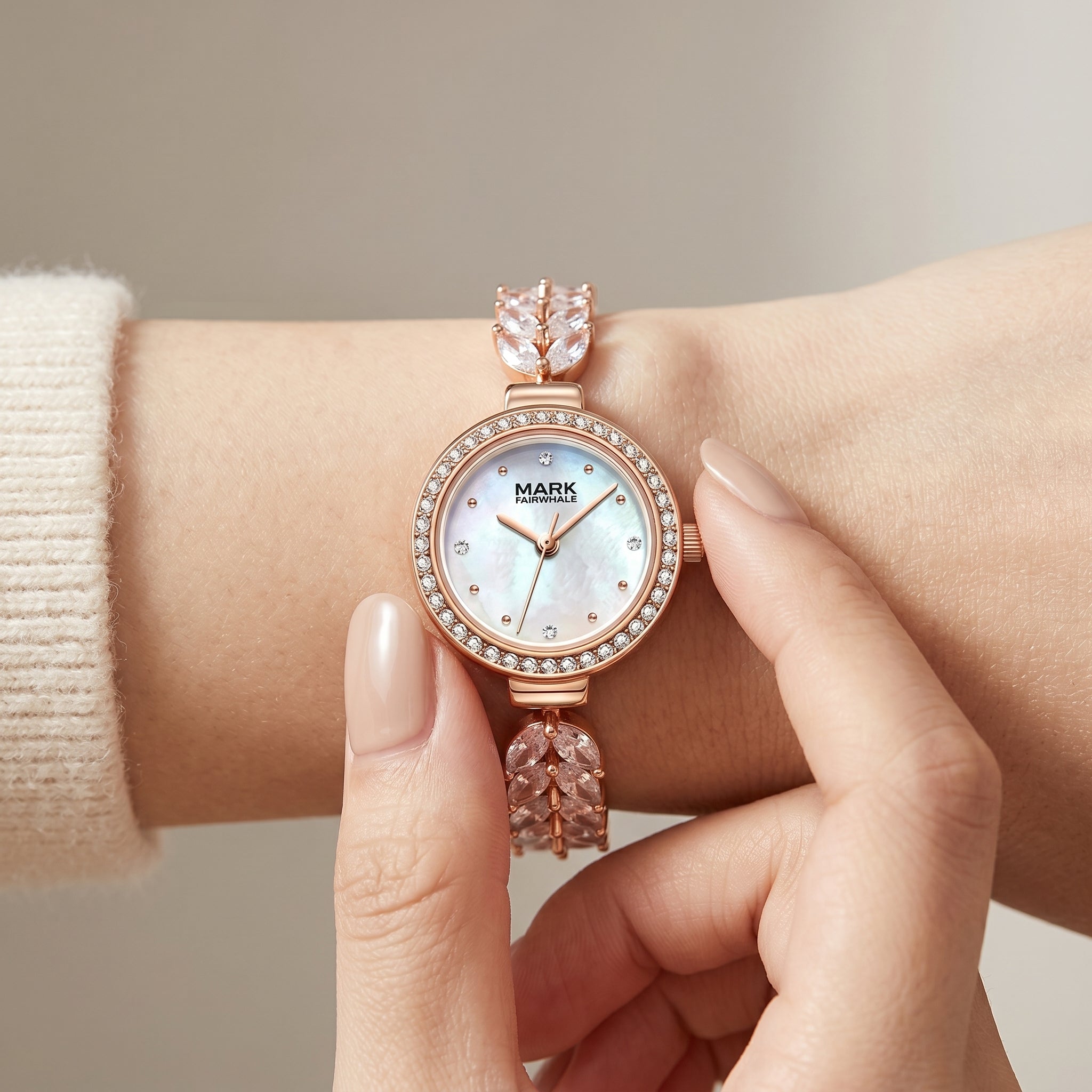 Mark Fairwhale women's rose gold quartz watch with crystal bezel, mother of pearl dial, decorative bracelet, and luxury wrist close up