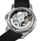 Mechanical watch with black strap and visible inner workings on a white background