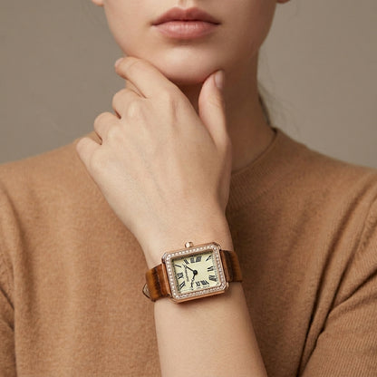 Person wearing a vintage-style watch with a brown strap on a neutral background