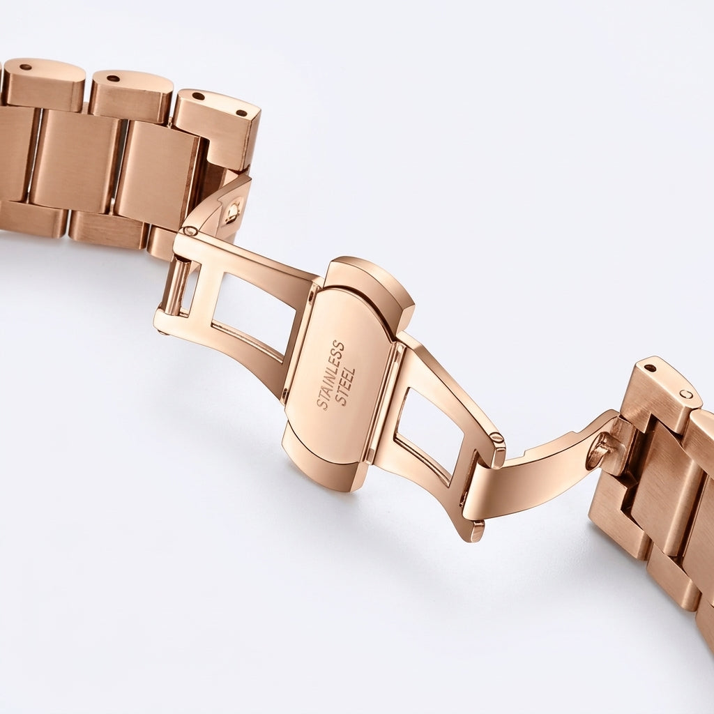 Rose gold watch bracelet on a light gray background