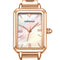 Rose gold watch with a white face on a white background