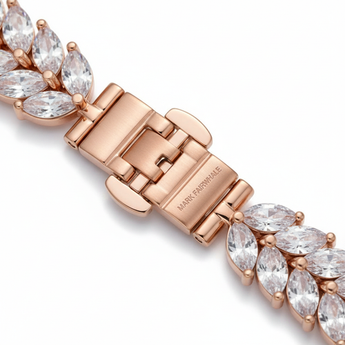Rose gold bracelet with diamond-like stones on a white background