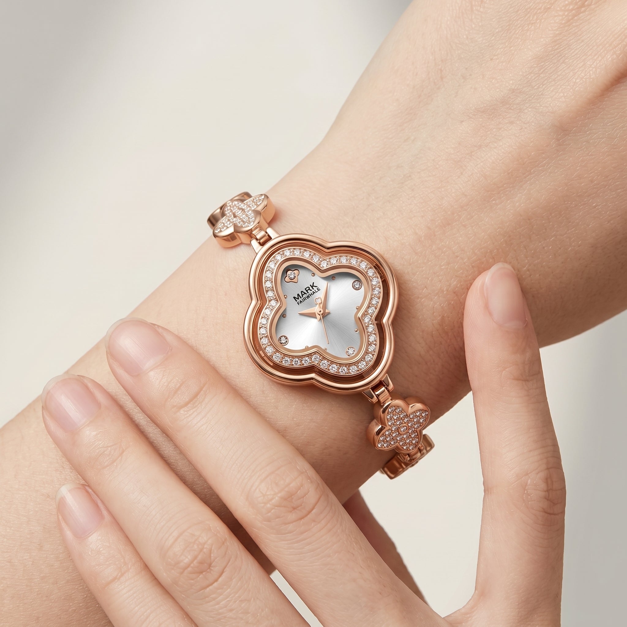 Rose gold heart-shaped watch on a wrist with a light background