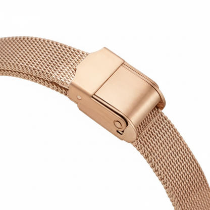 Rose gold mesh watch band with clasp on a white background