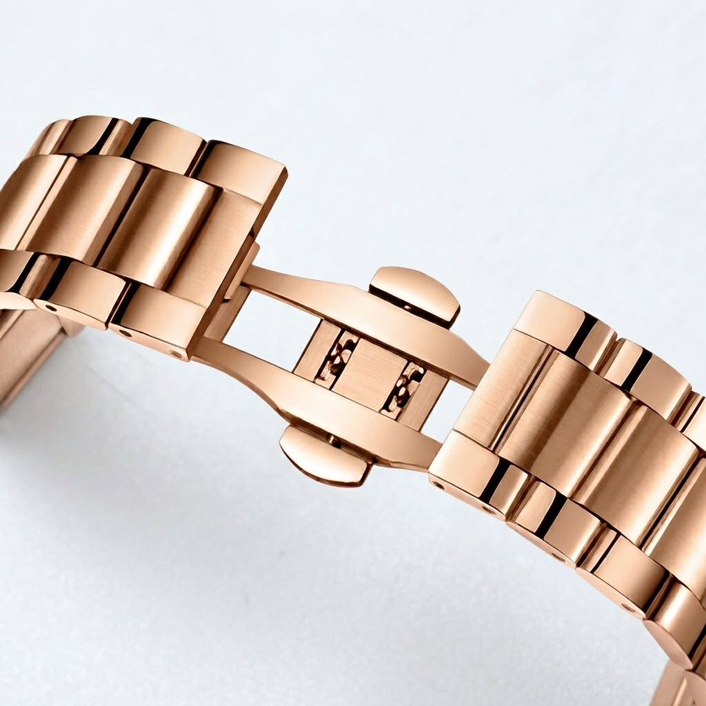 Rose gold watch bracelet on a light gray background