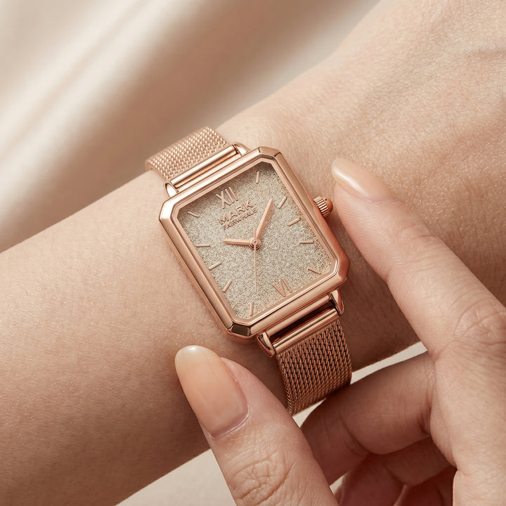 Rose gold watch on a wrist with a soft background