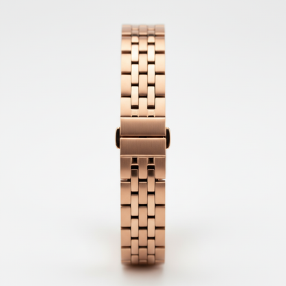 Rose gold watch strap on a light gray background