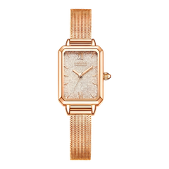 Rose gold watch with a black background