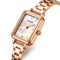 Rose gold watch with a white face on a white background