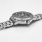 Silver watch with detailed face on a white background