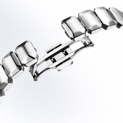 Silver bracelet with geometric links on a white background