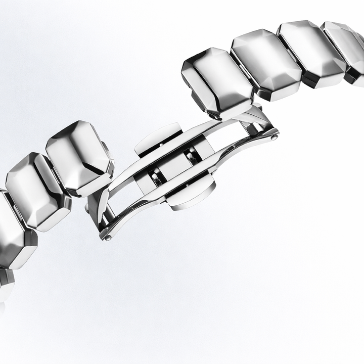 Silver bracelet with geometric links on a white background