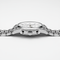 Silver watch with a detailed face on a white background