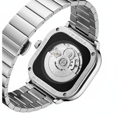 Silver watch with a detailed mechanical back on a white background