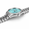 Silver watch with a turquoise dial on a white background