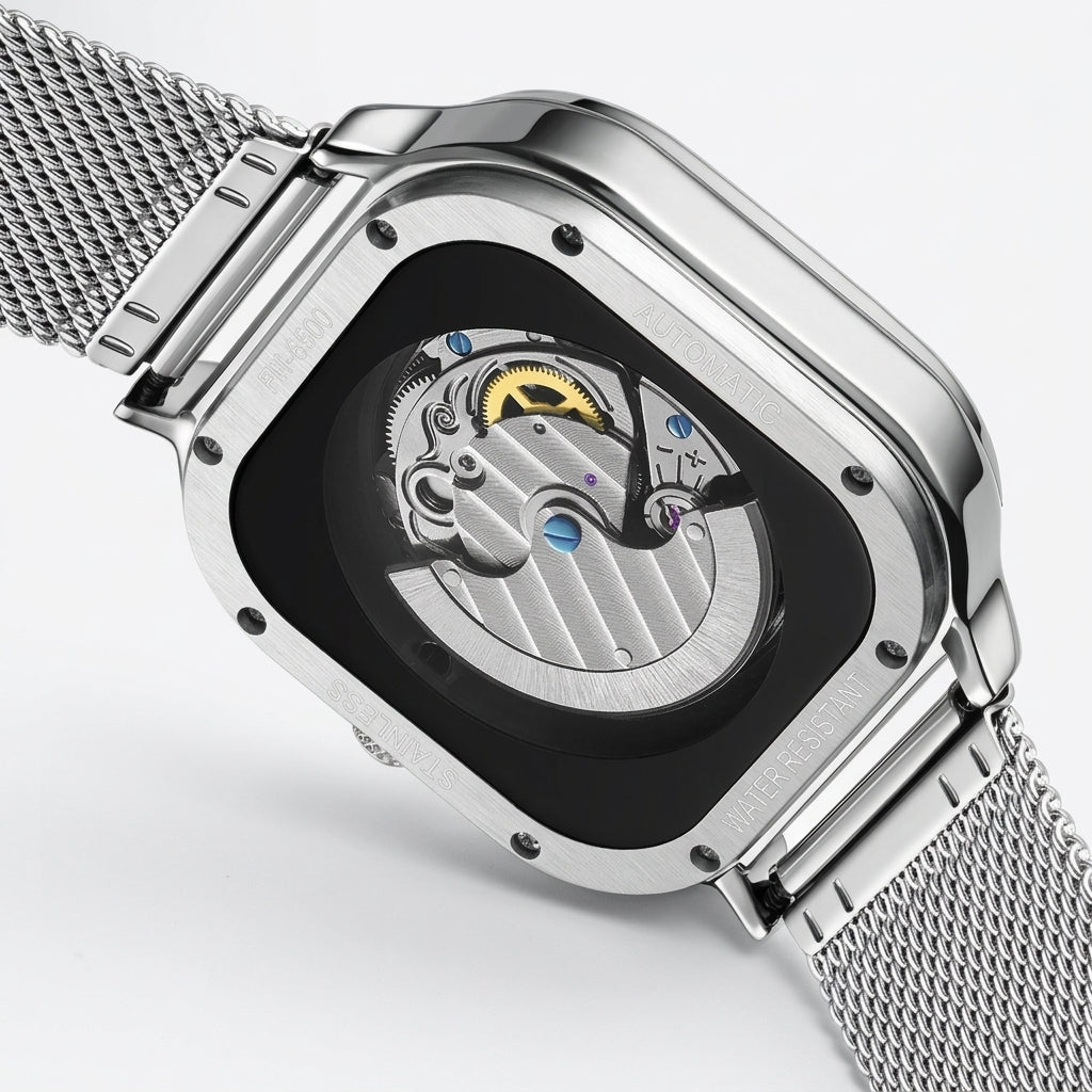 Silver watch with mesh band and open face design on a light gray background