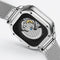 Silver watch with mesh band and open face design on a light gray background