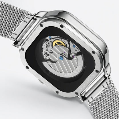 Silver watch with mesh band and open face design on a light gray background