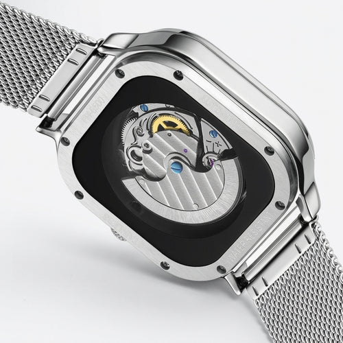 Silver watch with mesh band and open face design on a light gray background