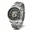 Silver wristwatch with a detailed mechanical face on a white background