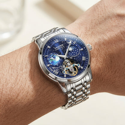 Silver wristwatch with a blue face on a person&