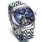 Silver wristwatch with a detailed blue face on a white background