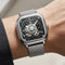 Silver wristwatch with black face on a person's wrist