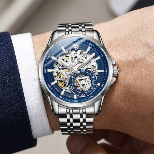 Silver wristwatch with blue face on a person&